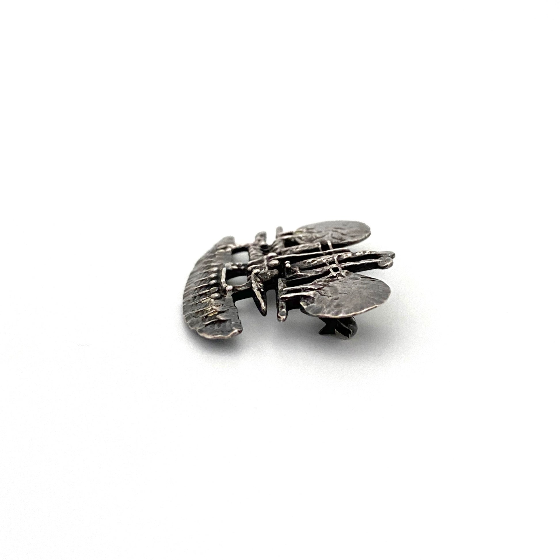 profile vintage brutalist pierced sculptural silver brooch Modernist jewelry design