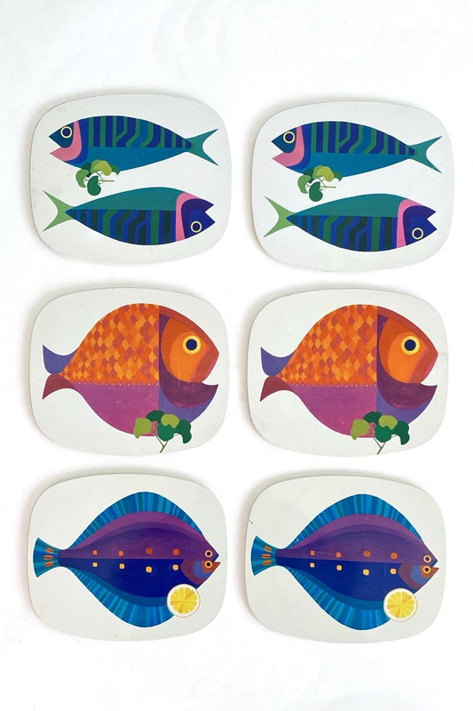 vintage metal and cork fish graphic trivets made in England mid century
